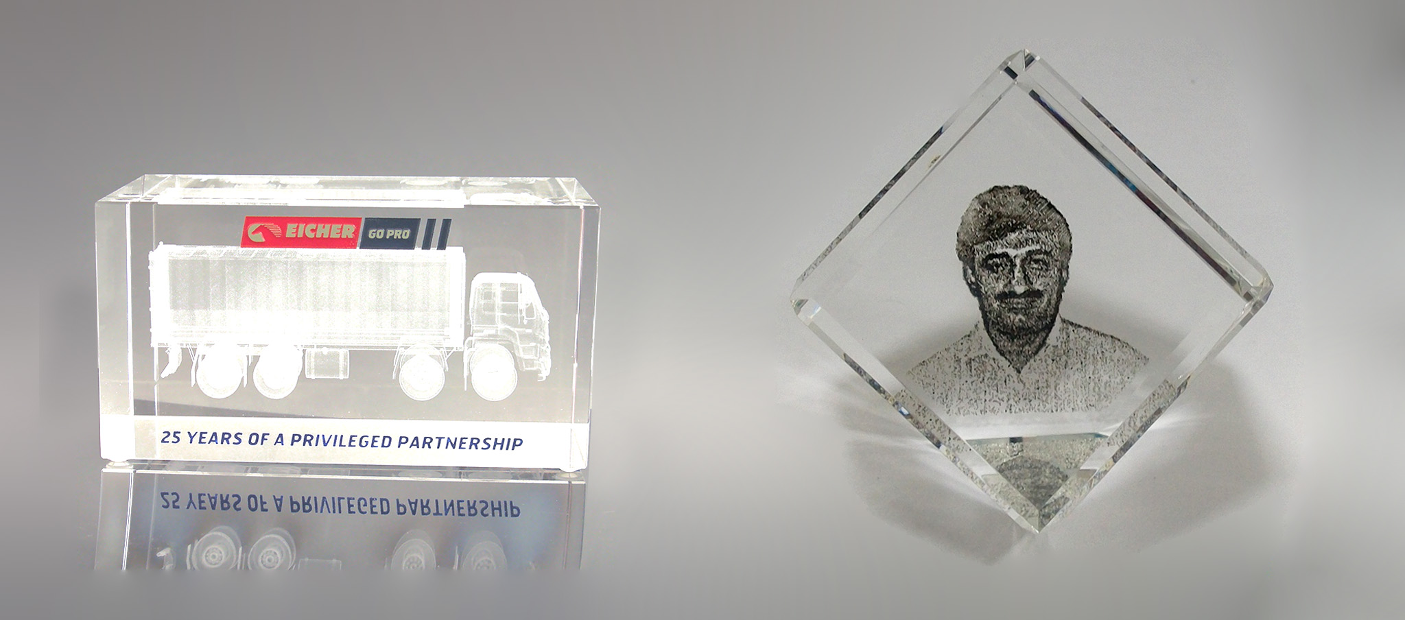 A 3D engraved crystal block featuring a picture of a man and a truck