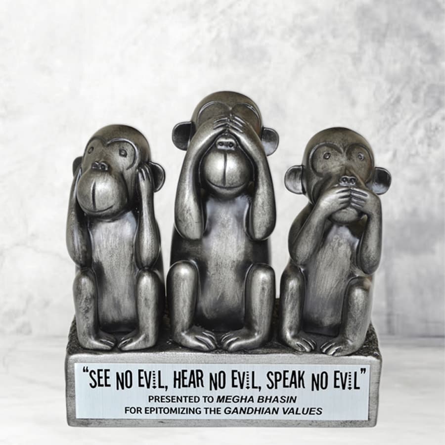 Three monkeys sitting side by side, each covering their eyes, mouth, and ears respectively with their hands.