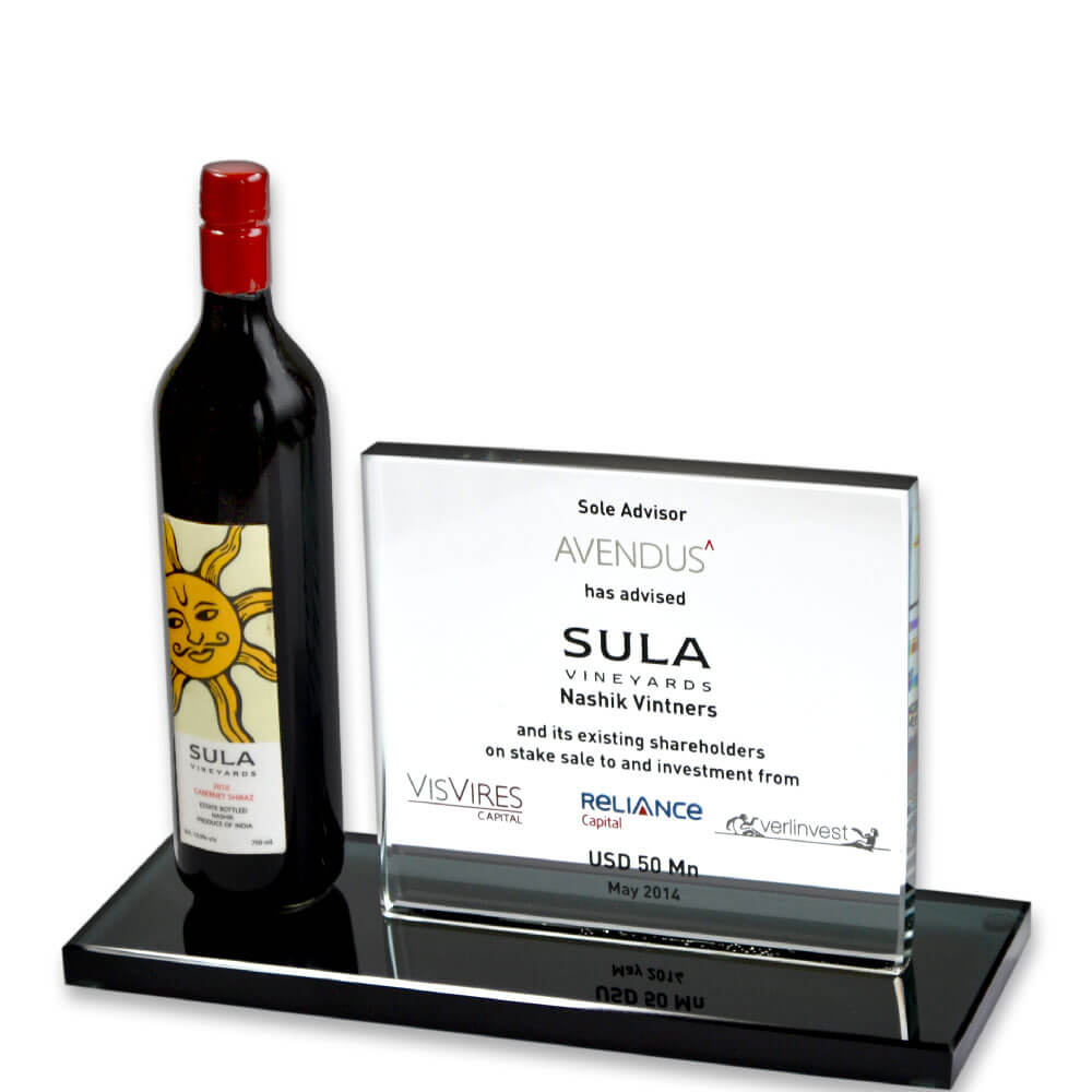 Elegant display featuring a sula bottle and award on a black glass surface, representing success