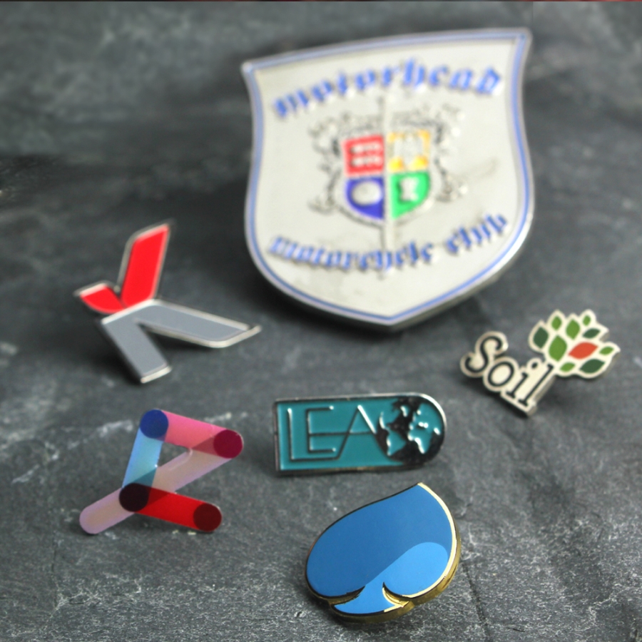A collection of badges and pins displayed on a table