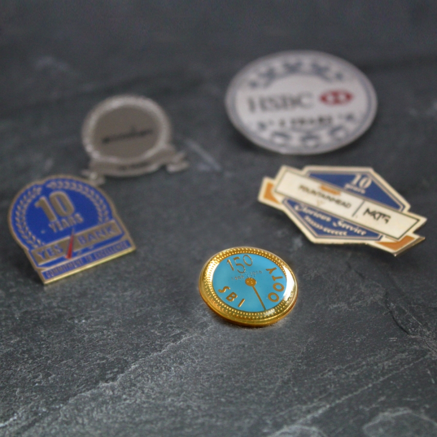 A collection of lapel pins and badges, showcasing