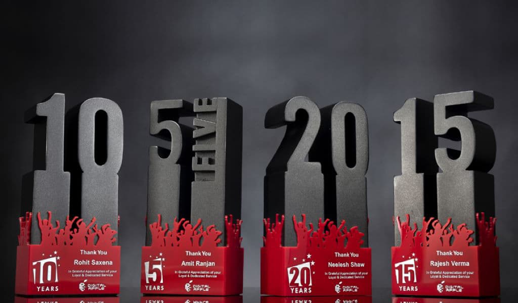 Beautiful heavy long service awards shaped in numbers of 5 years, 10 years, 15 years and 20 years showcase in an awards ceremony.