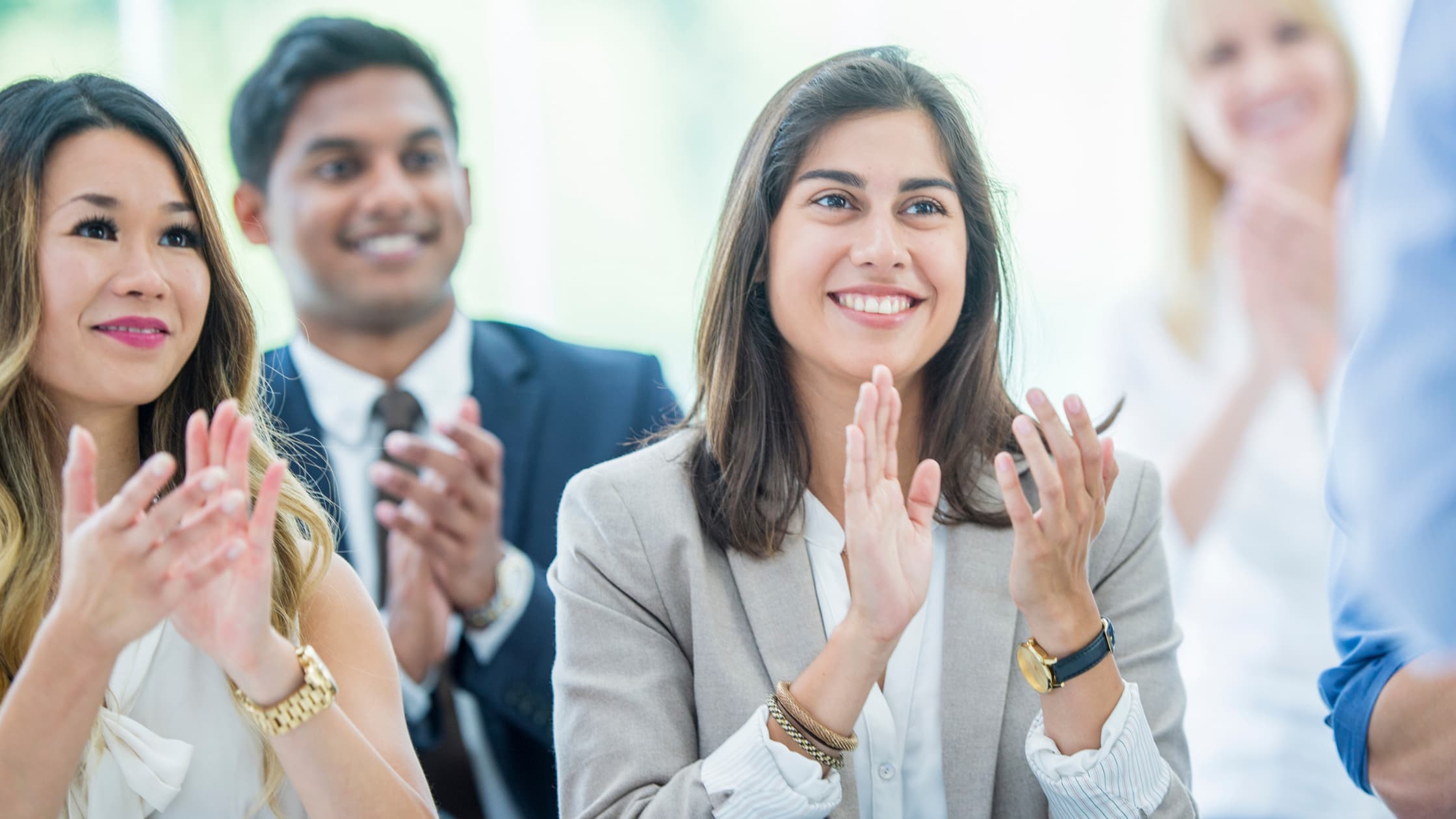 Team members clapping in the recognition program